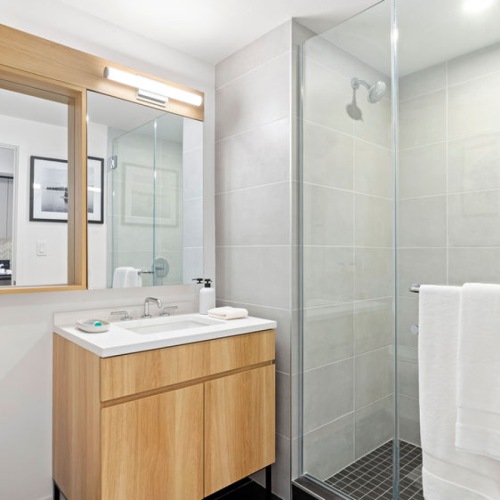 Bathroom Bathroom with floating sink, black tiles and glass shower door