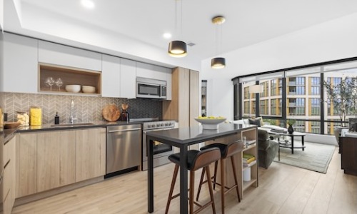 a kitchen with bar and chairs