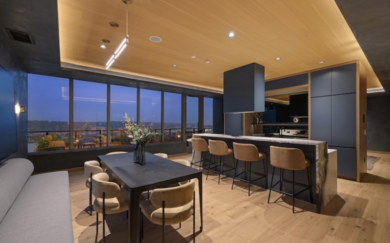 Lounge space with seating area and wall to wall windows with city views Lounge space with seating area and wall to wall windows with city views