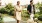 A man and woman walking their yellow Labrador along the riverfront