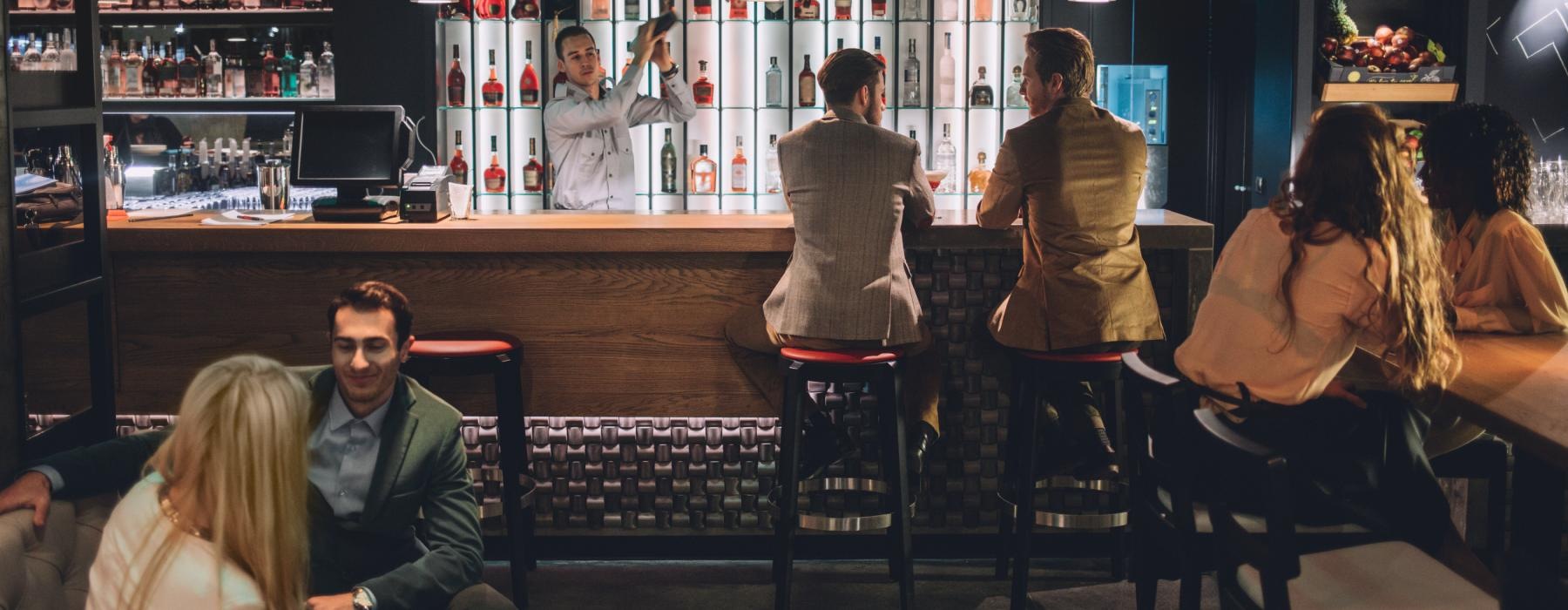 a group of people sitting at a bar